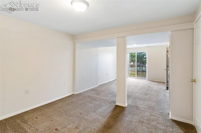 unfurnished room featuring baseboards and carpet floors