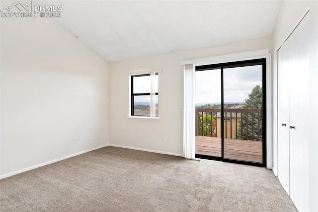 unfurnished room featuring lofted ceiling, carpet floors, baseboards, and visible vents