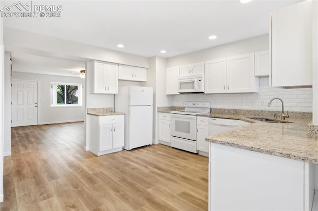 kitchen featuring a sink, white appliances, white cabinetry, and light wood-type flooring