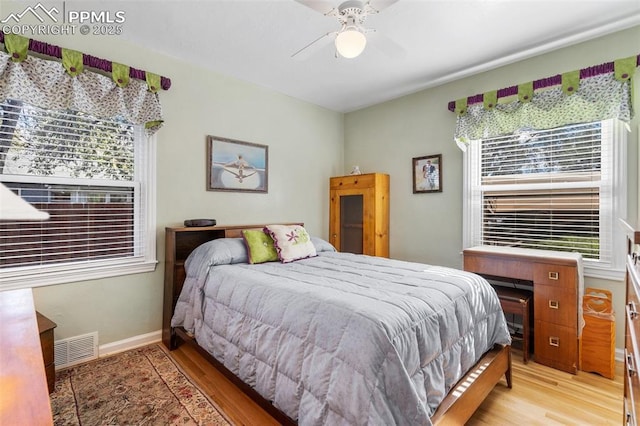bedroom with baseboards, ceiling fan, light wood-style flooring, and visible vents
