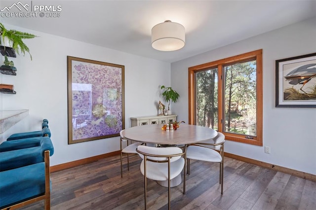 dining room featuring baseboards and wood finished floors