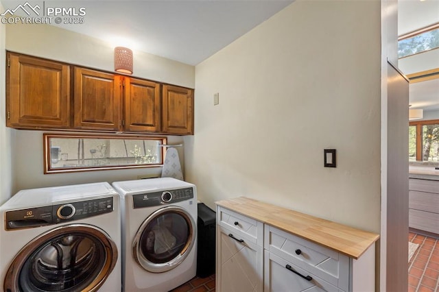 laundry room with cabinet space and washing machine and dryer