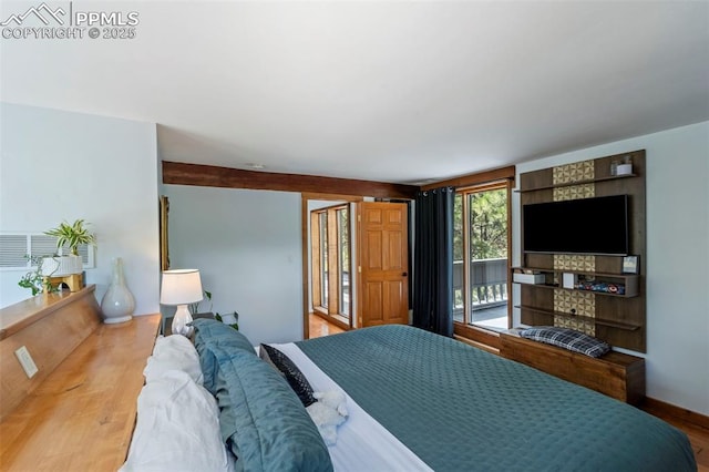 bedroom featuring access to outside, visible vents, and wood finished floors