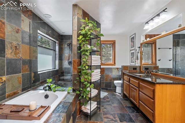 full bathroom featuring tile walls, a healthy amount of sunlight, a bath, and stone tile flooring
