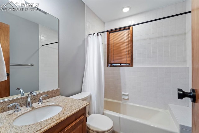full bathroom with vanity, shower / tub combo with curtain, and toilet