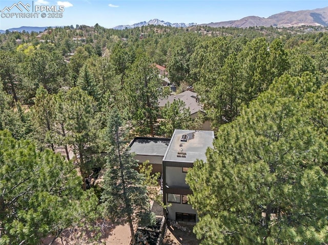 bird's eye view featuring a view of trees and a mountain view