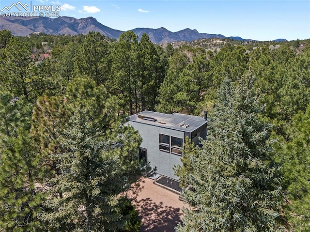 drone / aerial view with a view of trees and a mountain view
