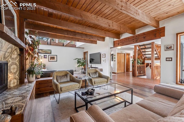 living area featuring wooden ceiling, beam ceiling, stairs, and hardwood / wood-style floors