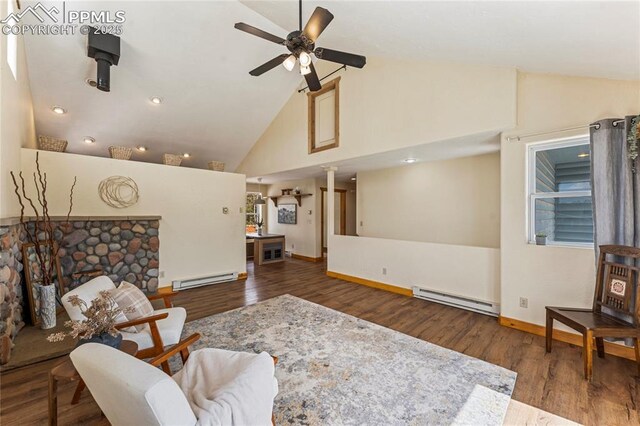 3543 Blue Mesa Dr, Divide, CO 80814 - living area featuring baseboard heating, ceiling fan, wood finished floors, baseboards, and high vaulted ceiling