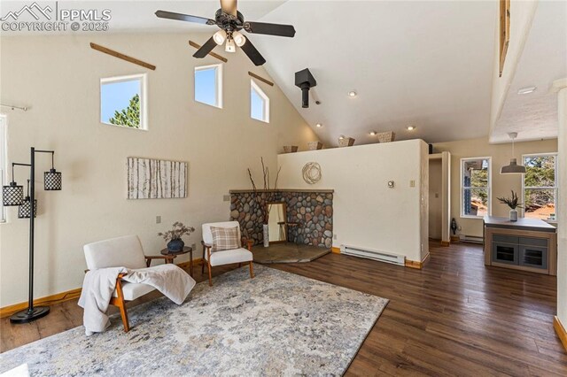 3543 Blue Mesa Dr, Divide, CO 80814 - living room featuring baseboard heating, ceiling fan, wood finished floors, high vaulted ceiling, and baseboards