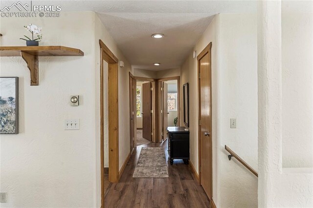 3543 Blue Mesa Dr, Divide, CO 80814 - hall with dark wood-style floors, baseboards, an upstairs landing, recessed lighting, and a textured wall