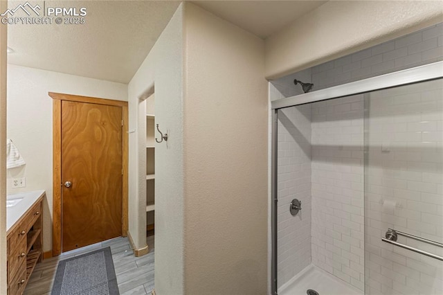 3543 Blue Mesa Dr, Divide, CO 80814 - full bath featuring a stall shower, vanity, and wood finished floors