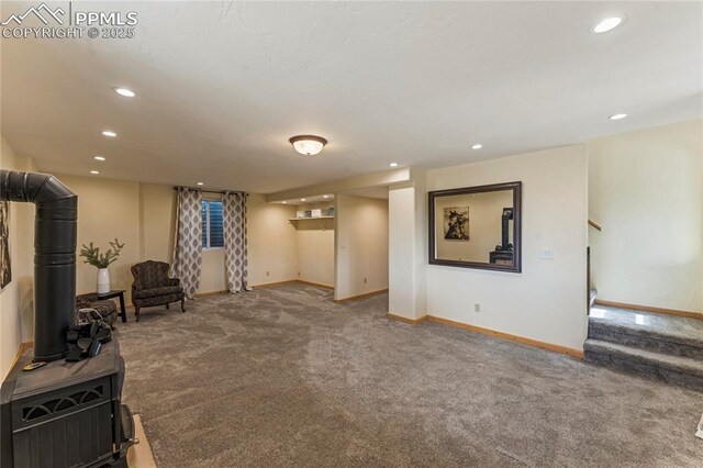 3543 Blue Mesa Dr, Divide, CO 80814 - finished below grade area featuring carpet flooring, baseboards, a wood stove, recessed lighting, and stairway