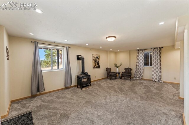3543 Blue Mesa Dr, Divide, CO 80814 - living area featuring a wood stove, carpet floors, baseboards, and recessed lighting