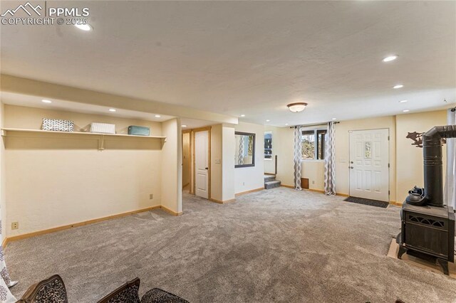 3543 Blue Mesa Dr, Divide, CO 80814 - below grade area with a wood stove, recessed lighting, carpet floors, baseboards, and stairs