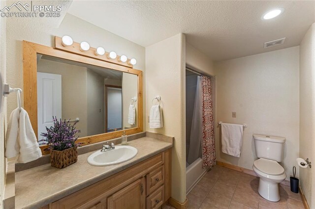 3543 Blue Mesa Dr, Divide, CO 80814 - full bath featuring toilet, tile patterned floors, vanity, a textured ceiling, and shower / bath combination with curtain