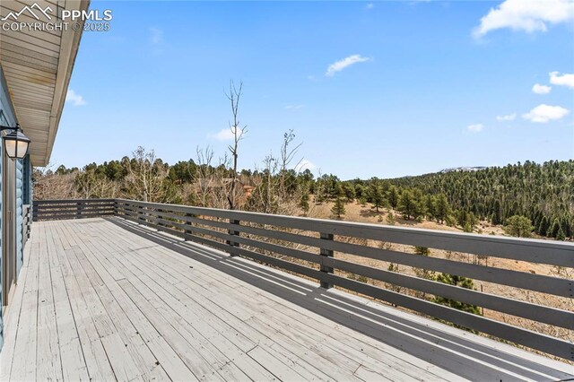 3543 Blue Mesa Dr, Divide, CO 80814 - wooden deck featuring a wooded view