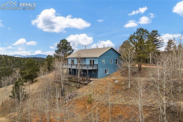 3543 Blue Mesa Dr, Divide, CO 80814 - back of property with a deck with mountain view and metal roof