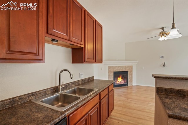 2121 Gilpin Ave, Colorado Springs, CO 80910 - kitchen with a sink, dark countertops, and light wood finished floors
