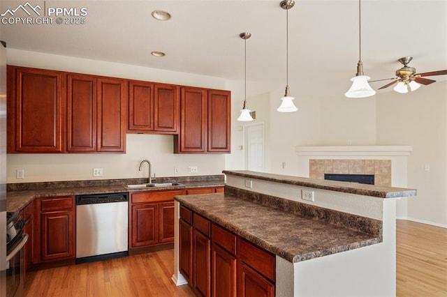 2121 Gilpin Ave, Colorado Springs, CO 80910 - kitchen with stainless steel appliances, a sink, dark countertops, light wood-type flooring, and recessed lighting
