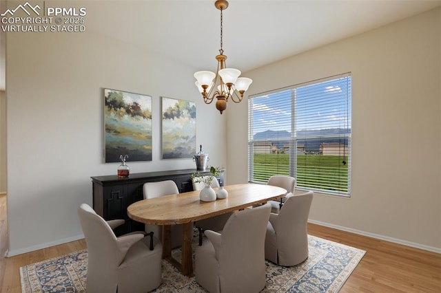 2121 Gilpin Ave, Colorado Springs, CO 80910 - dining area featuring a chandelier, baseboards, and light wood-style flooring