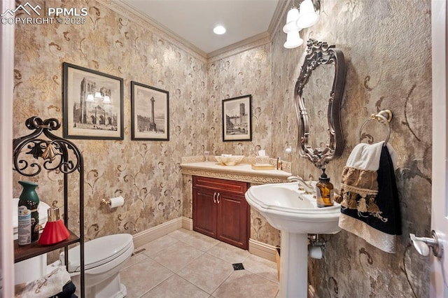bathroom featuring crown molding, toilet, baseboards, and tile patterned flooring
