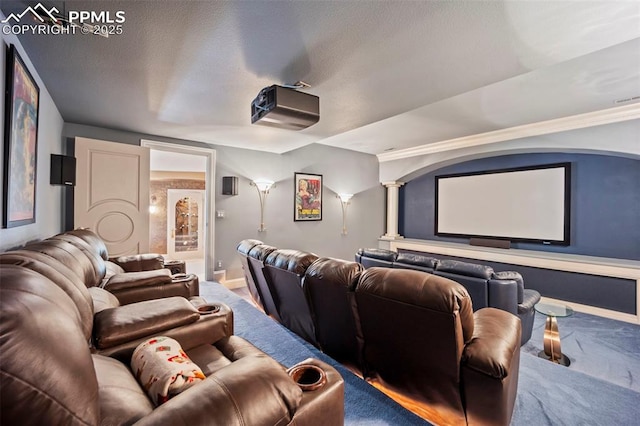 carpeted cinema featuring baseboards