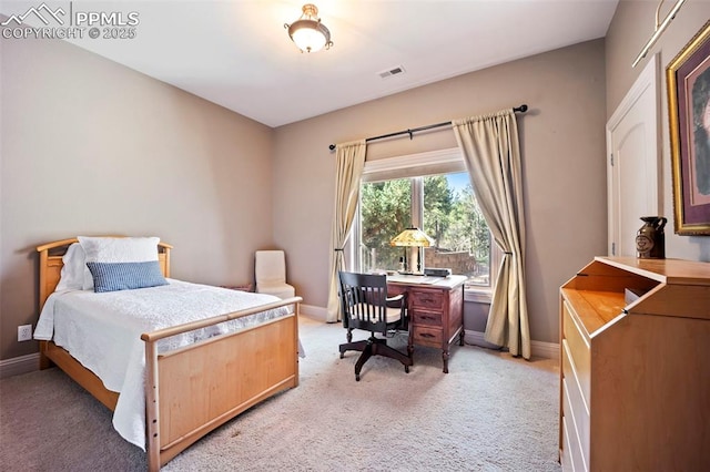 bedroom featuring baseboards, visible vents, and light colored carpet