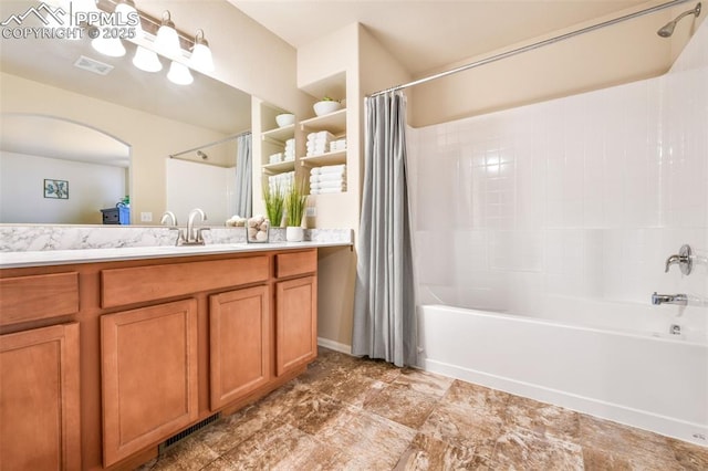 bathroom featuring visible vents, shower / bath combo, and vanity