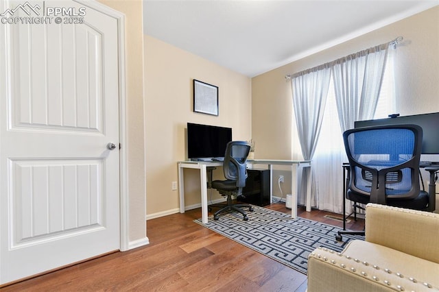 office area featuring baseboards and wood finished floors