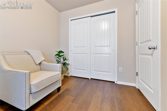 living area with baseboards and dark wood finished floors