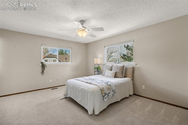 bedroom featuring baseboards, multiple windows, and light colored carpet