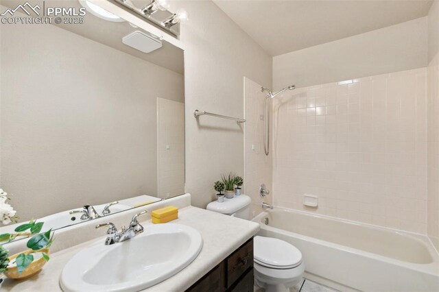 full bathroom featuring toilet, shower / bathing tub combination, and vanity