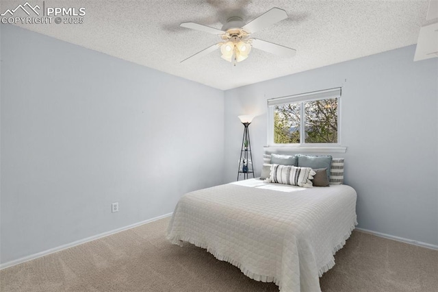 bedroom featuring baseboards, a textured ceiling, and carpet