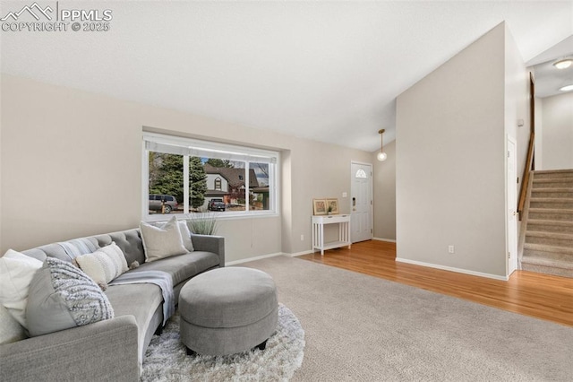 carpeted living room featuring baseboards, stairs, and lofted ceiling
