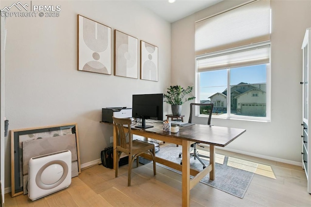 10323 Elevated Ln, Colorado Springs, CO 80924 - home office with baseboards and light wood-type flooring