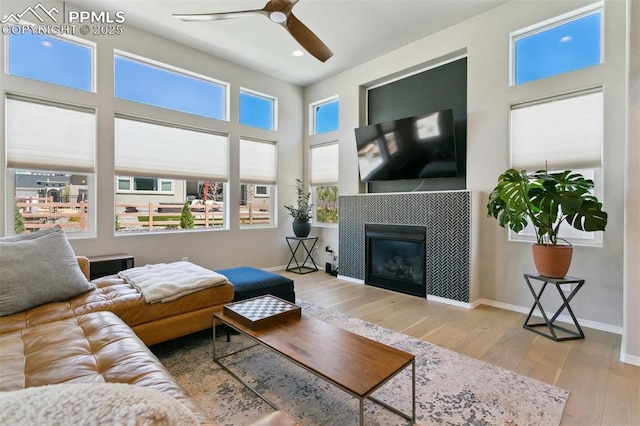 10323 Elevated Ln, Colorado Springs, CO 80924 - living room featuring wood finished floors, recessed lighting, ceiling fan, baseboards, and a tile fireplace