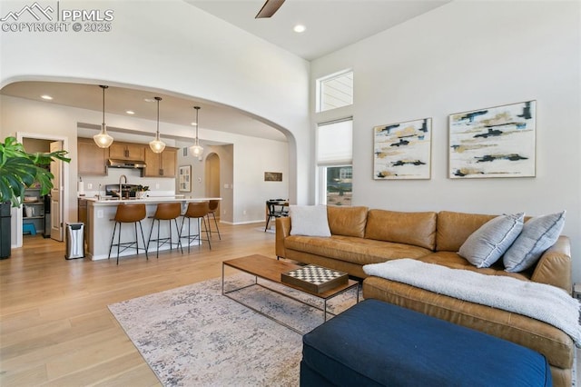 10323 Elevated Ln, Colorado Springs, CO 80924 - living area featuring arched walkways, recessed lighting, light wood finished floors, and ceiling fan