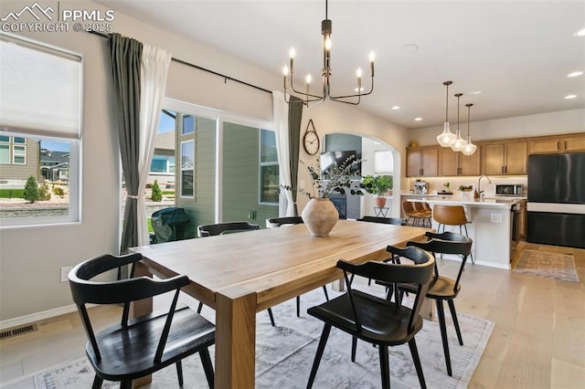 10323 Elevated Ln, Colorado Springs, CO 80924 - dining room with visible vents, recessed lighting, a chandelier, arched walkways, and light wood-style floors