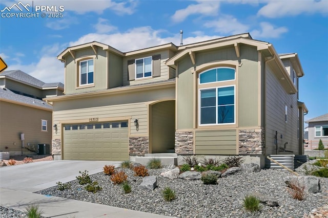 10323 Elevated Ln, Colorado Springs, CO 80924 - craftsman-style house with stone siding, driveway, an attached garage, and cooling unit