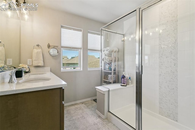 10323 Elevated Ln, Colorado Springs, CO 80924 - full bath with a shower stall, baseboards, double vanity, and a sink