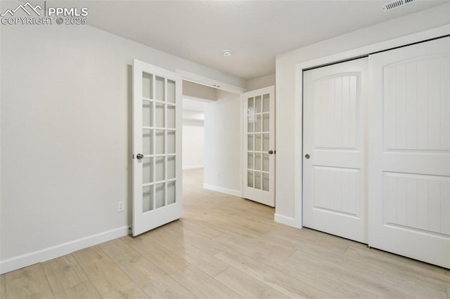10323 Elevated Ln, Colorado Springs, CO 80924 - interior space featuring a closet, french doors, visible vents, light wood-style flooring, and baseboards