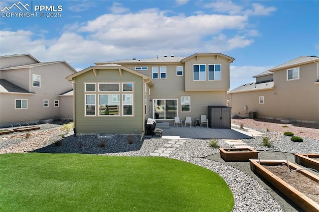 10323 Elevated Ln, Colorado Springs, CO 80924 - rear view of house with a yard, a patio, central air condition unit, and a garden