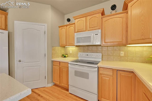 kitchen with white appliances, light countertops, light wood-type flooring, and light brown cabinets