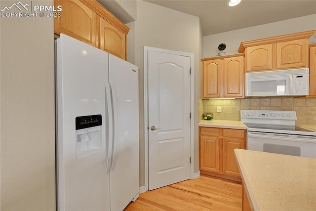 kitchen with light wood-style floors, white appliances, light countertops, light brown cabinets, and decorative backsplash
