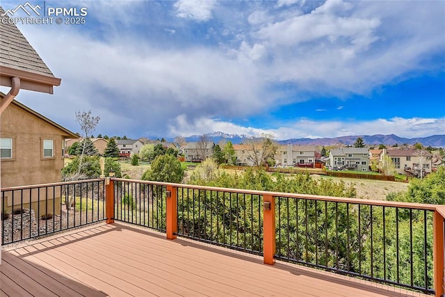 deck featuring a residential view and a mountain view