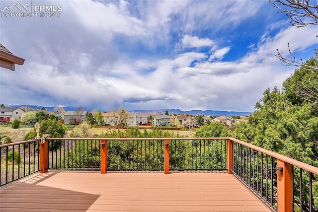 deck with a residential view and a mountain view