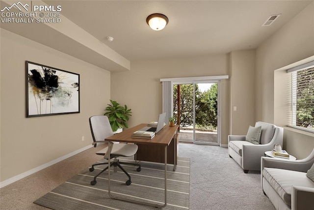 office area featuring carpet flooring, baseboards, and visible vents