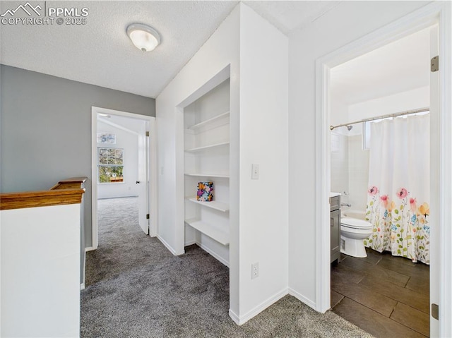 3130 Haystack Dr, Colorado Springs, CO 80922 - hall with a textured ceiling, baseboards, built in features, and carpet