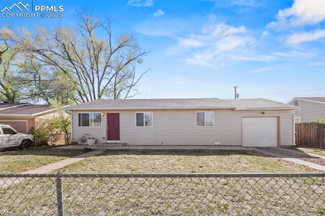 2246 Bison Dr, Colorado Springs, CO 80911 - ranch-style house featuring an attached garage, a front lawn, driveway, and fence private yard